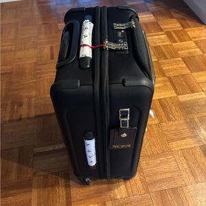 Tumi Black Travel Luggage with Gold Accents